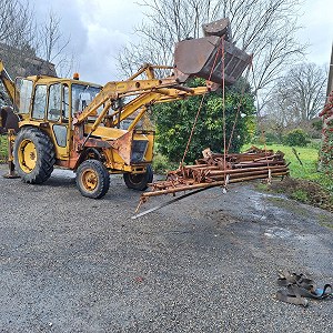 Tractor loader with backhoe and scaffolding.  